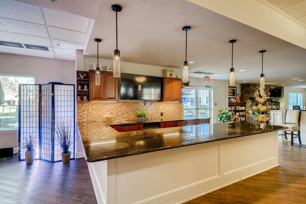 A modern kitchen with pendant lighting and a spacious countertop.