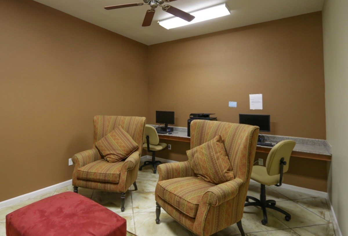 A cozy office space with comfortable seating and computer workstations.