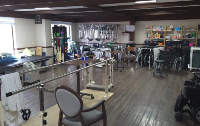 A rehabilitation room equipped with various physical therapy tools and equipment.