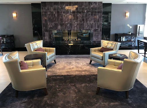 A stylish living room featuring modern chairs, a sleek fireplace, and elegant decor.