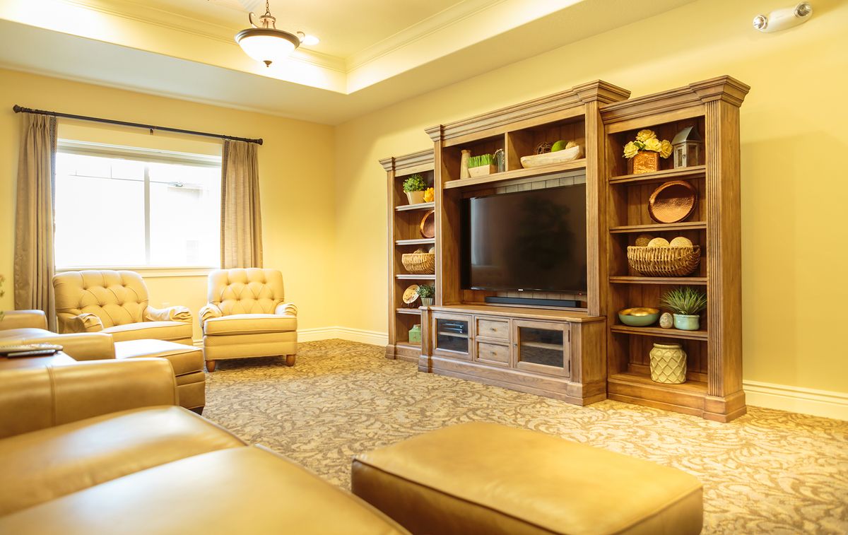 A cozy living room with comfortable seating and a large entertainment center.
