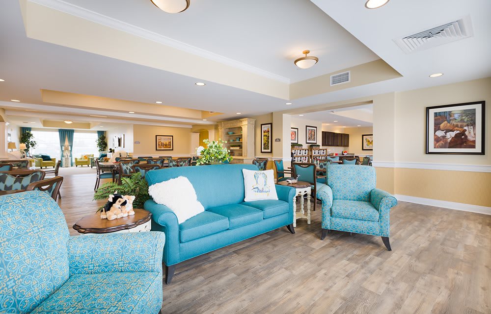 A cozy living room with blue furniture and inviting decor.