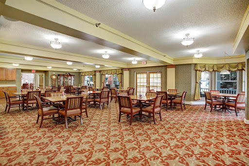 A spacious dining area featuring elegant furniture and a warm atmosphere.