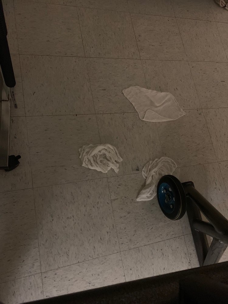 Tissues scattered on a tiled floor near a wheel.