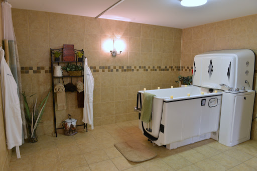A serene bathroom space featuring a large bathtub and neatly arranged towels, perfect for relaxation.
