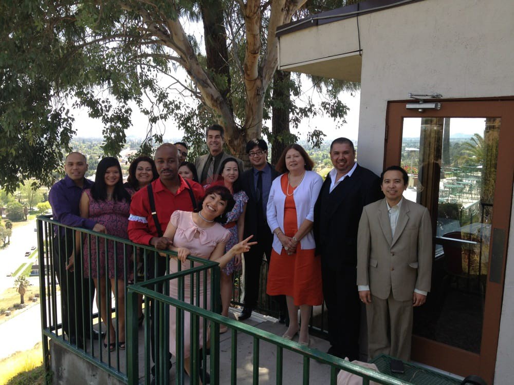 A group of people posing for a formal outdoor photo.