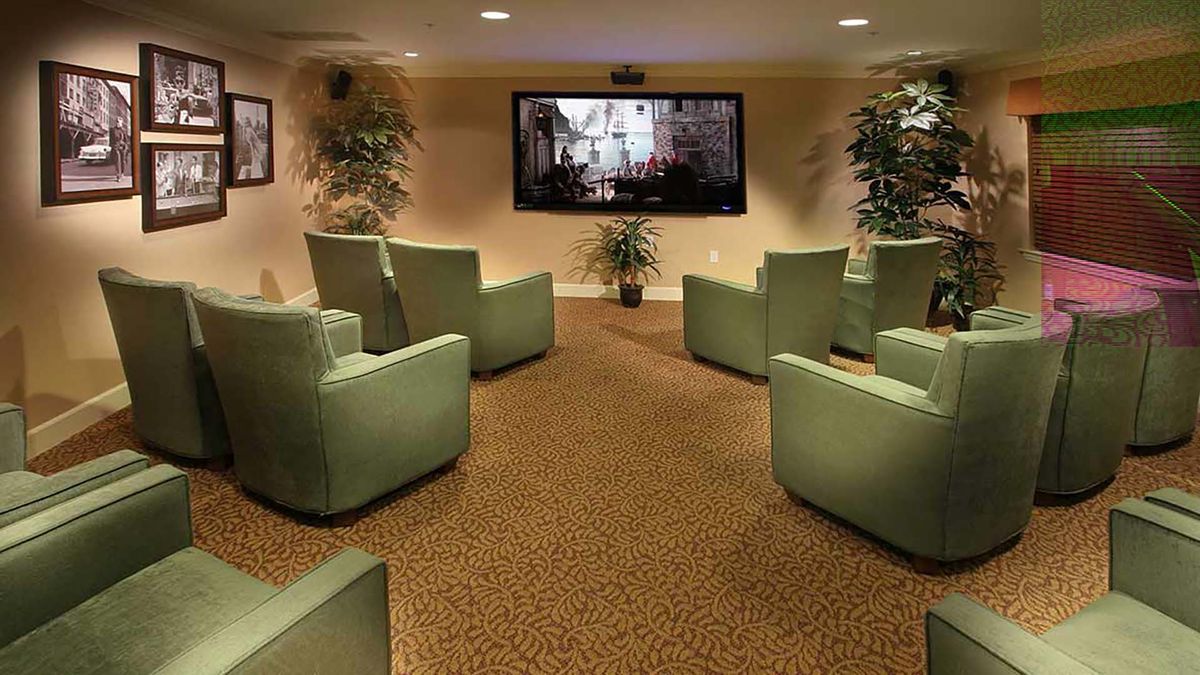 A cozy home theater with ample seating and a large screen for an immersive viewing experience.