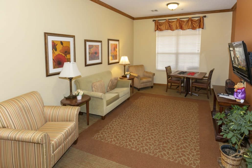 A cozy living room with sofas, chairs, and decorative artwork.