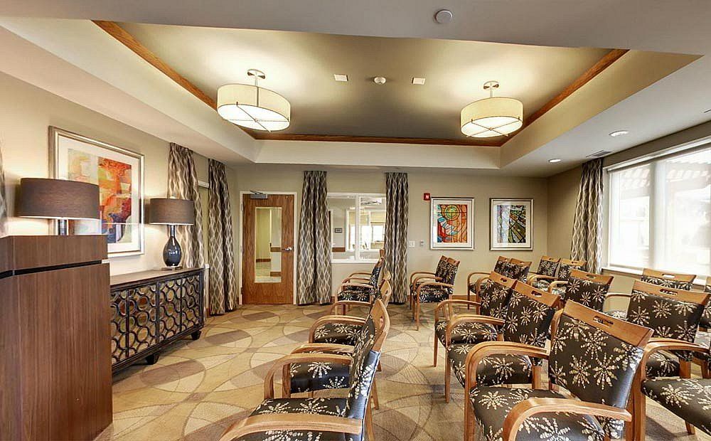 A stylishly decorated waiting room with patterned chairs and elegant lighting.