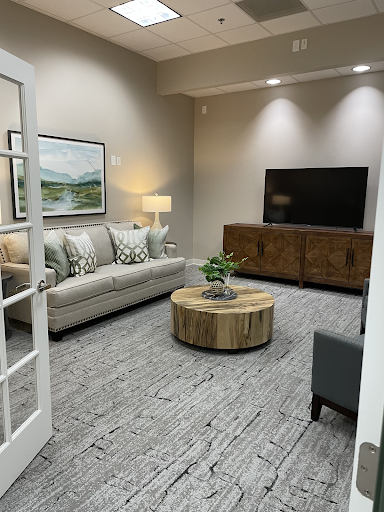 A cozy and modern living room setup featuring a comfortable sofa, stylish coffee table, and a wall-mounted television.