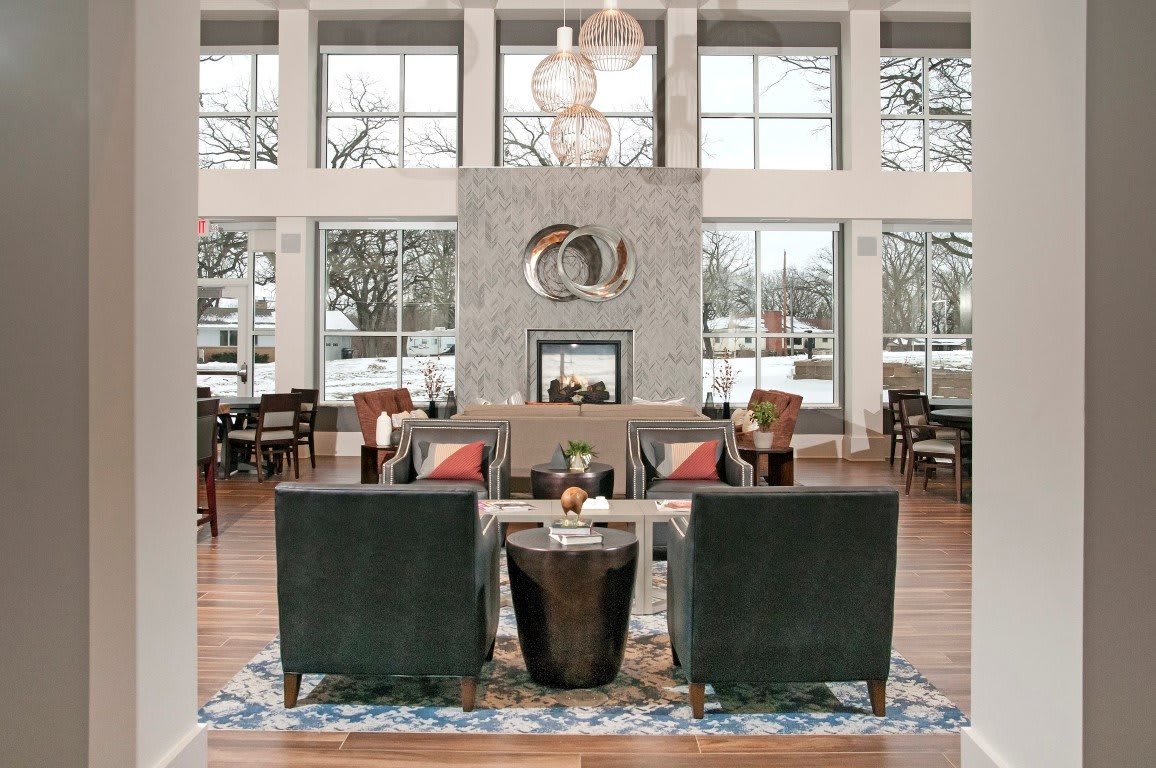 A modern lounge area with stylish furniture and large windows overlooking a snowy landscape.