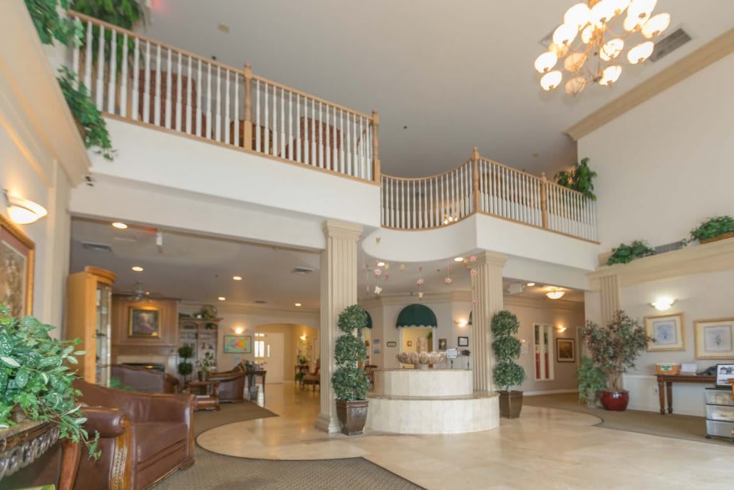A spacious hotel lobby with elegant decor and a reception desk.