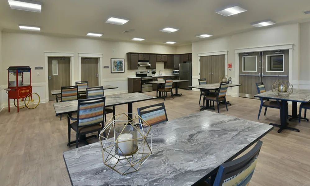 A modern kitchen and dining area with neatly arranged tables and chairs.