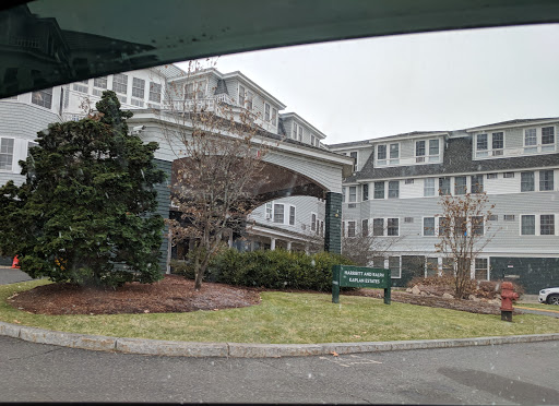 A view of a residential building with landscaped surroundings.