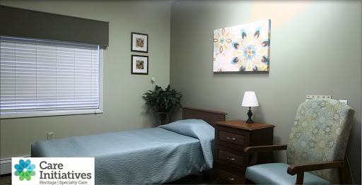 A cozy and well-decorated bedroom featuring a single bed, nightstand with lamp, and decorative wall art.