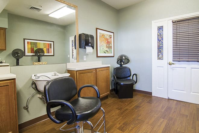 Modern hair salon interior with styling chairs and washing station.