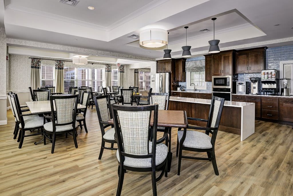 A modern dining area with wooden floors, stylish furniture, and contemporary lighting fixtures.