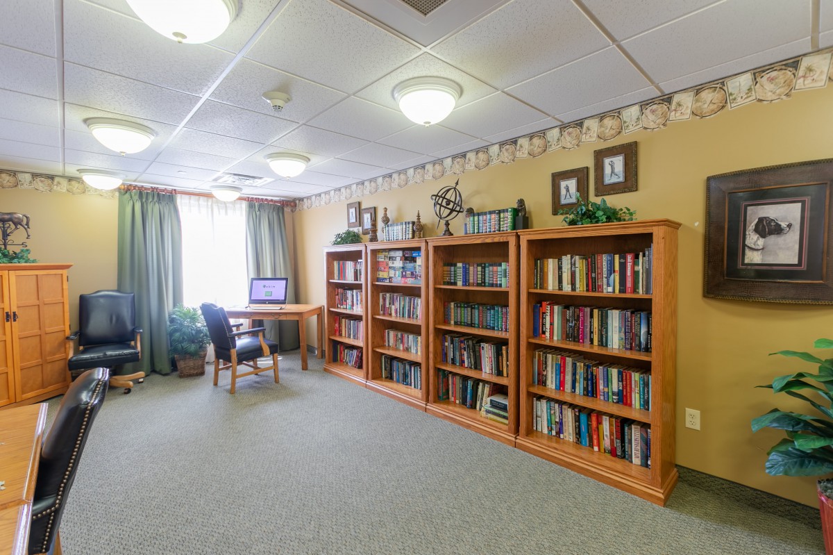 A cozy library corner with bookshelves and a reading desk.