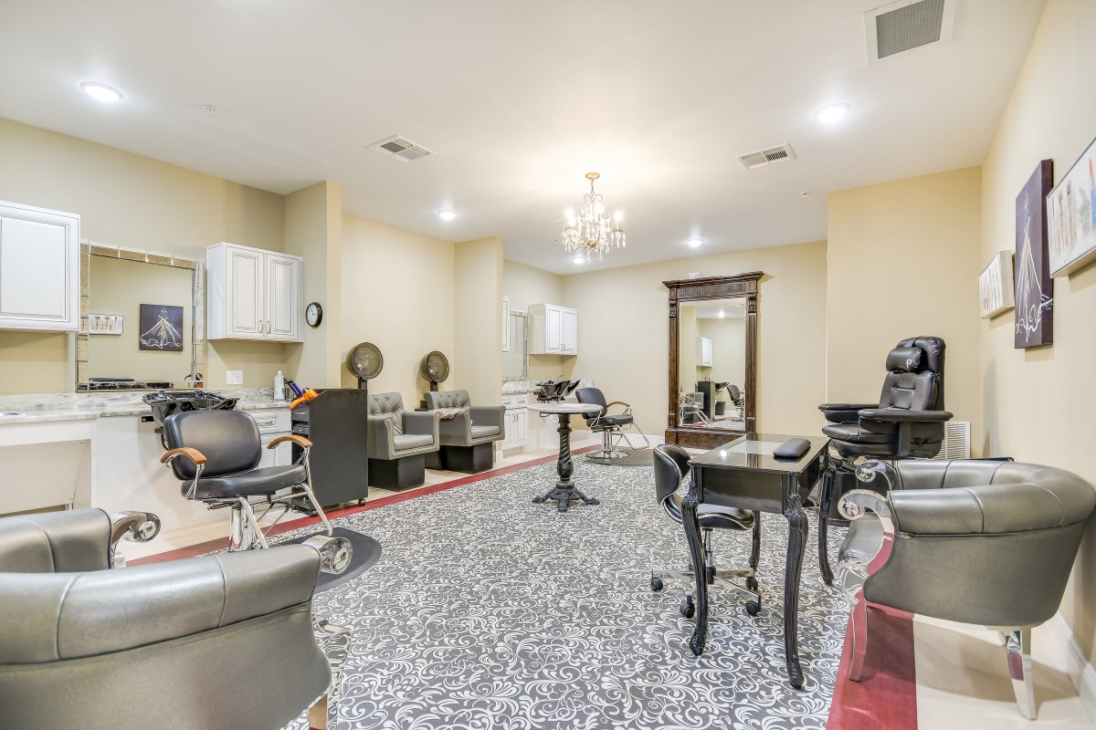 A stylish and well-equipped hair salon interior with chairs, mirrors, and modern decor.