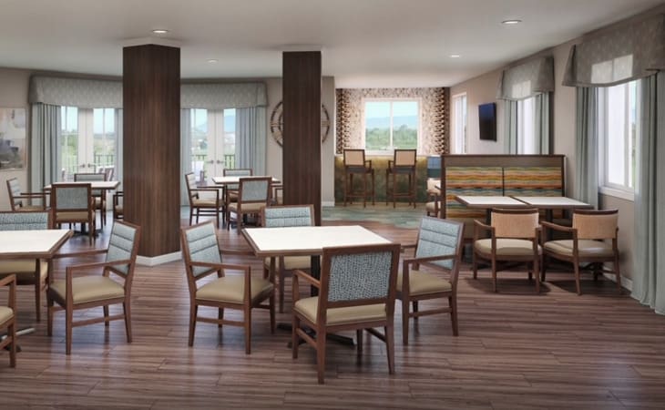 A modern dining area with tables and chairs arranged in a spacious setting.
