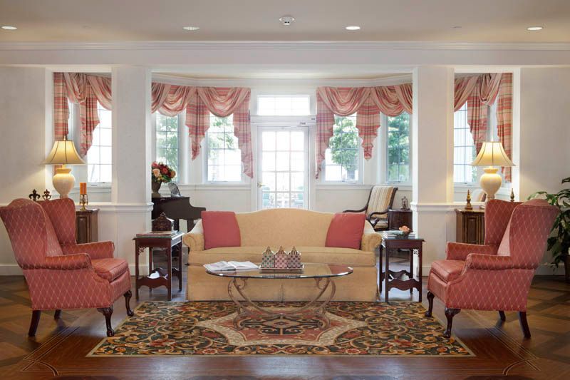 Elegant living room with classic decor and large windows.