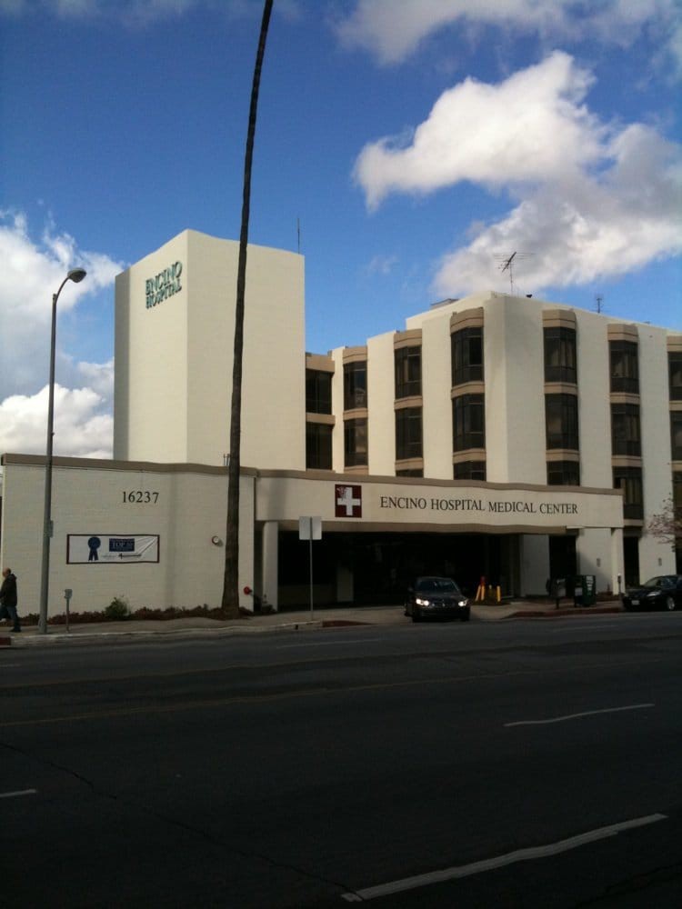 A view of a hospital building with clear skies in the background.