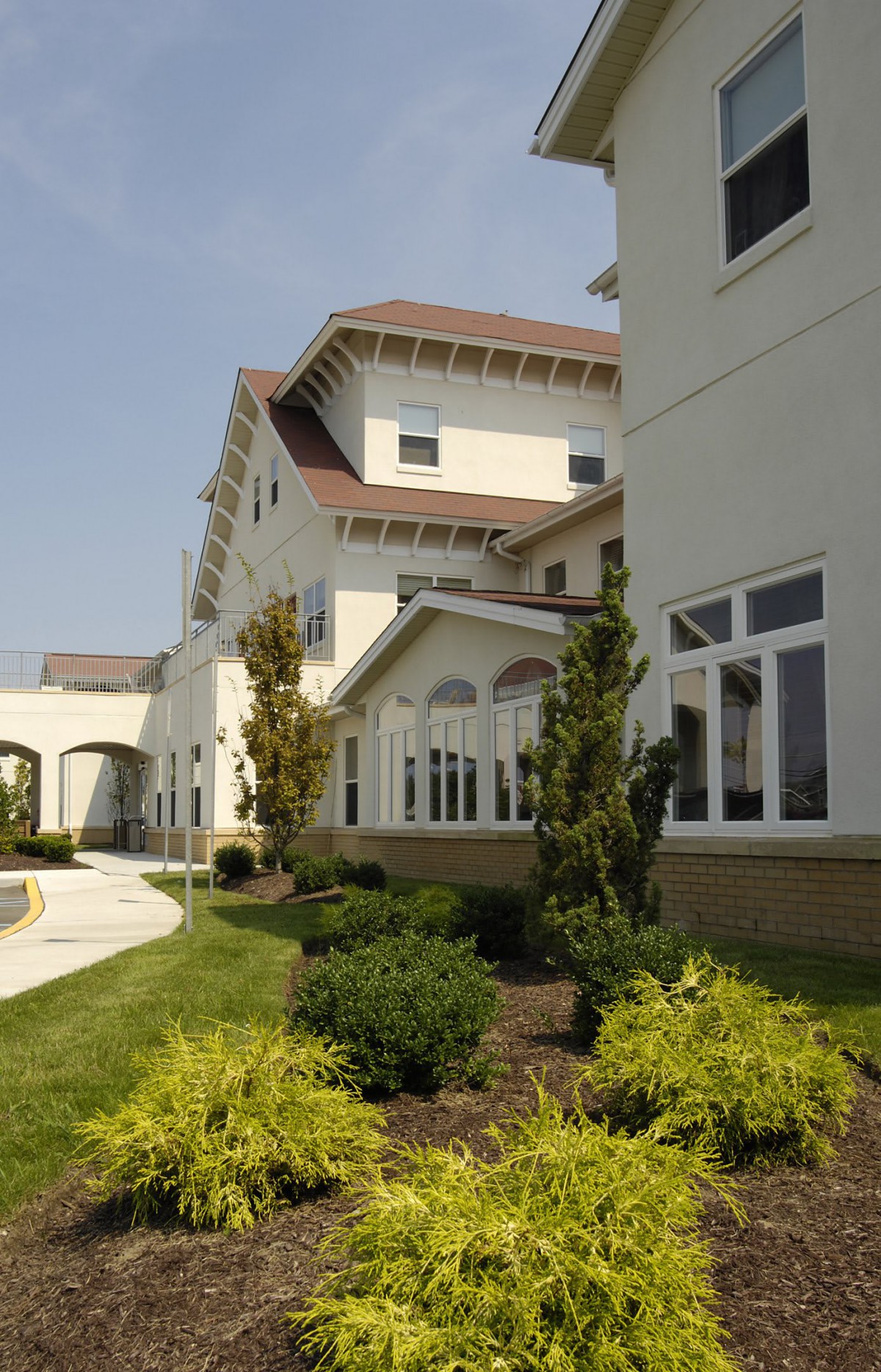 A modern building with well-maintained landscaping and large windows.
