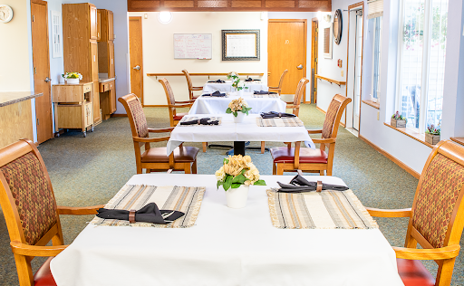 A neatly arranged dining area with tables set for a meal, showcasing elegant decor.
