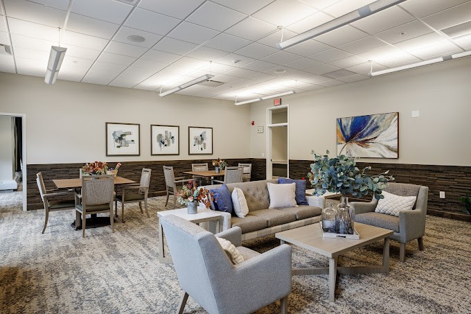 A modern lounge area with comfortable seating and decorative artwork.
