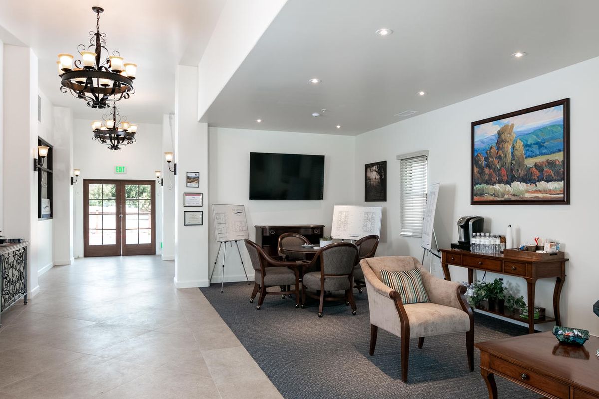 A modern lobby with comfortable seating, a large television, and stylish decor.