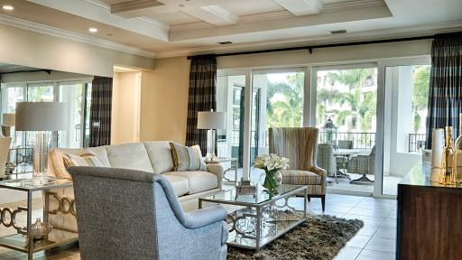 A beautifully designed living room featuring comfortable seating and elegant decor, enhanced by natural light.