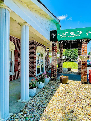 Entrance of Flint Ridge with welcoming signage and landscaped surroundings.