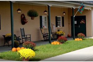A cozy porch with rocking chairs and vibrant flowers.