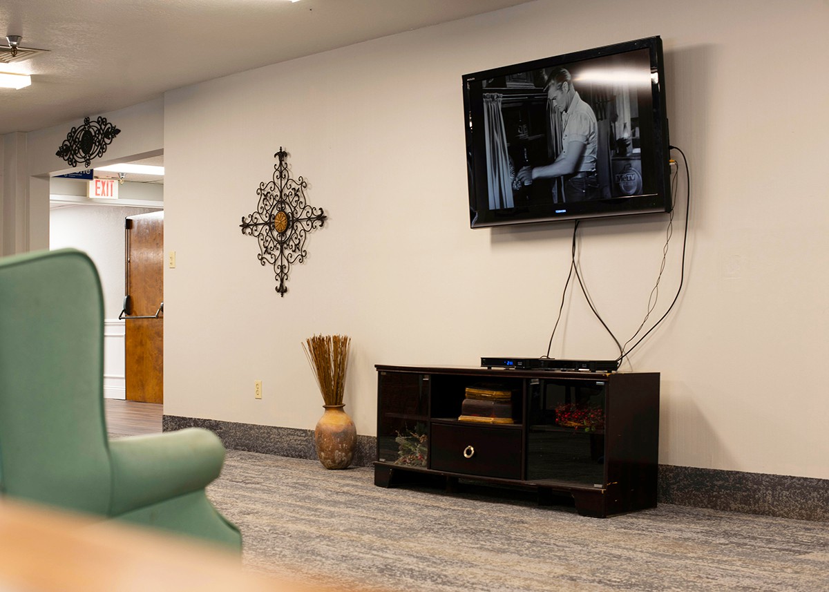A modern living room with a wall-mounted TV and stylish decor.