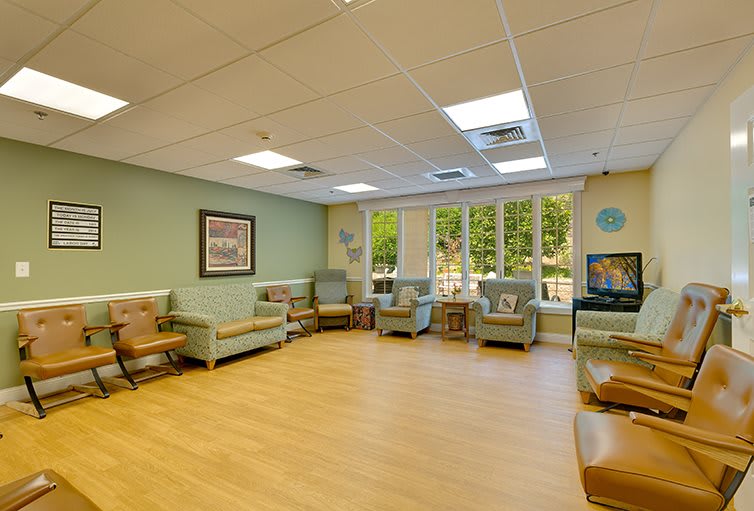 A cozy waiting room with comfortable chairs and large windows.