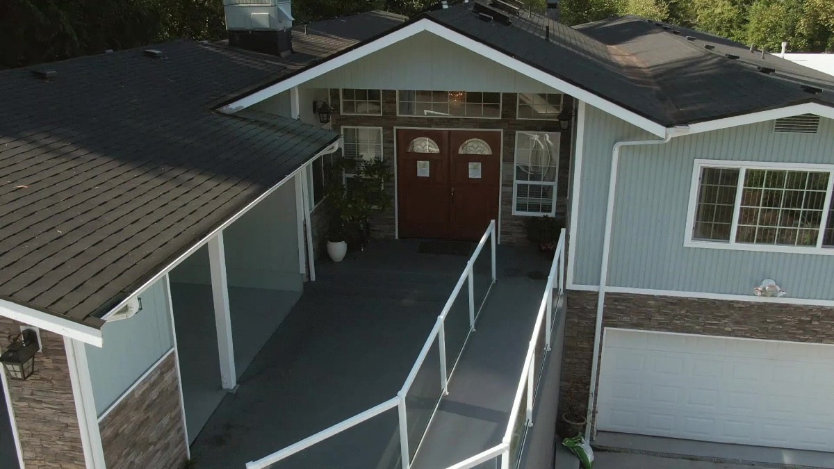 A house entrance with a ramp leading to the front doors.