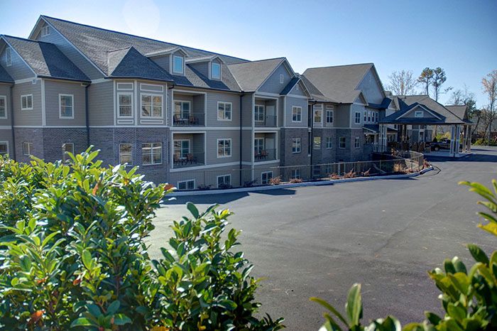 Exterior view of a multi-story apartment building with balconies.