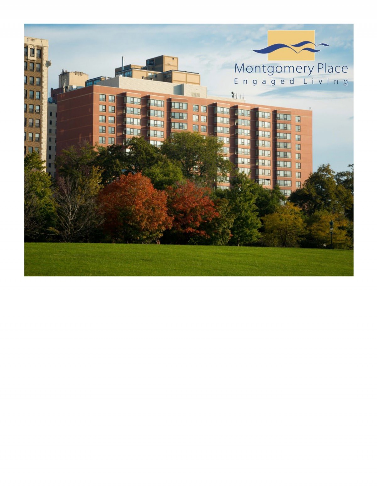An apartment building viewed across a park with autumn foliage.