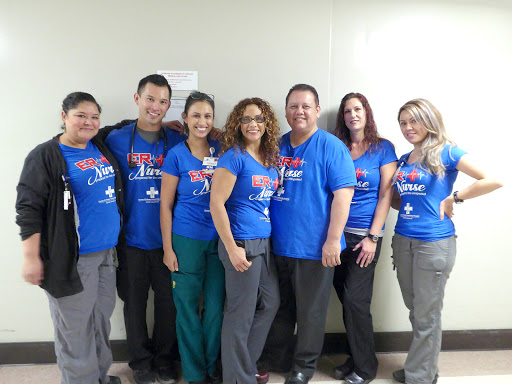 A cheerful team of healthcare professionals in matching blue shirts.
