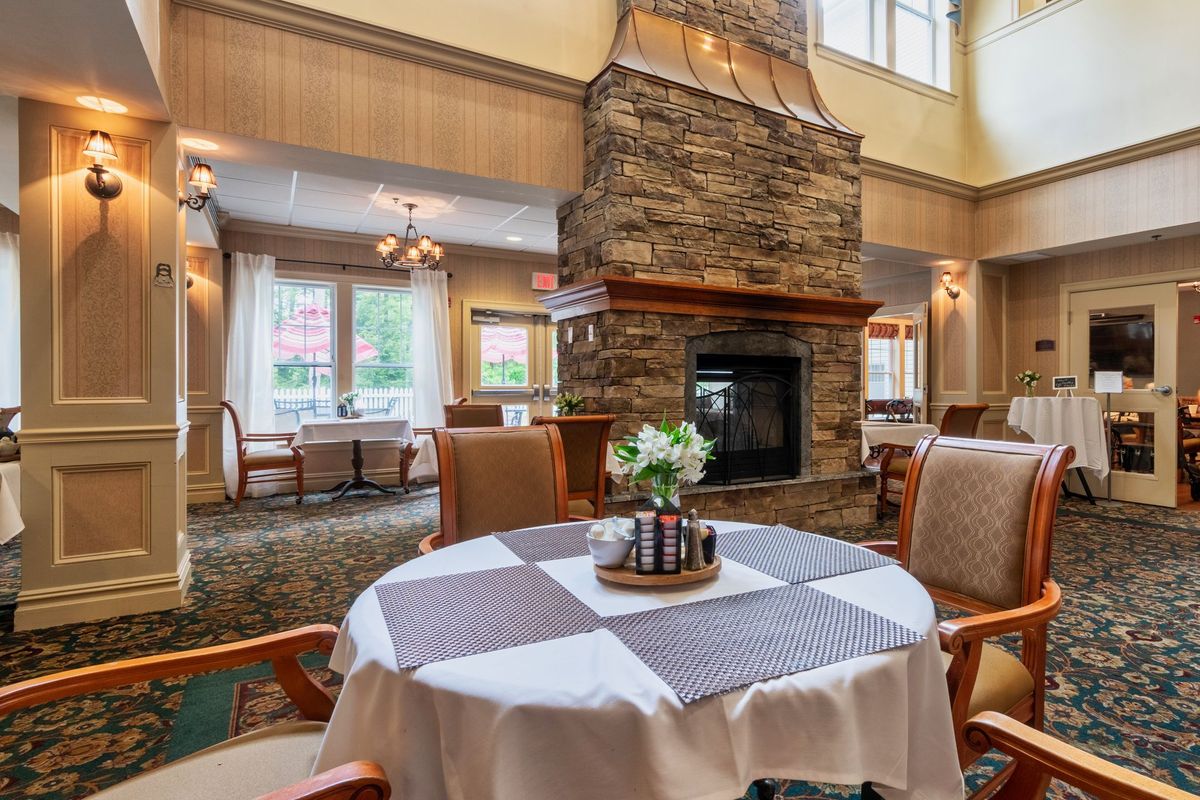 A cozy dining area with a stone fireplace and elegant table setting.