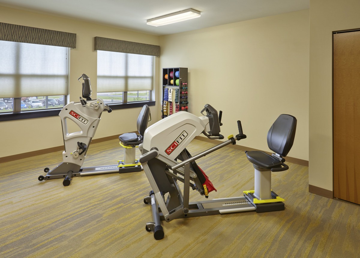 A gym room featuring specialized exercise equipment for rehabilitation and fitness.