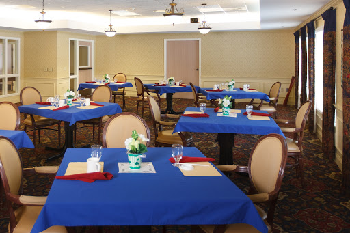 A cozy dining area set up with blue tablecloths and decorative elements for guests.