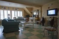 A spacious living room with comfortable furniture and natural light.