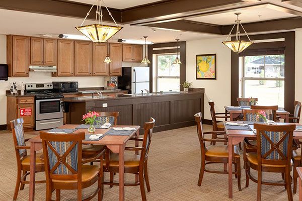 A modern dining area with wooden furniture and an adjacent kitchen.