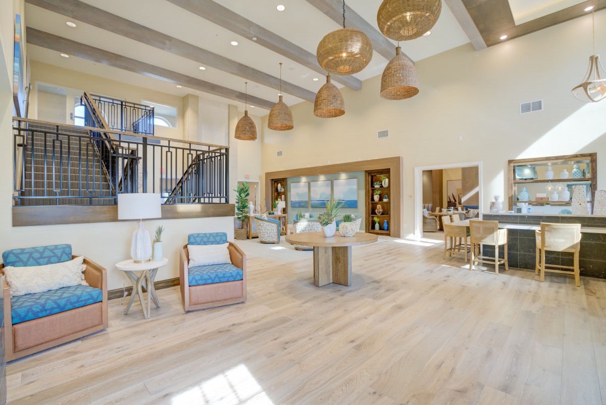 A spacious and modern lobby with natural light, featuring comfortable seating and stylish lighting.