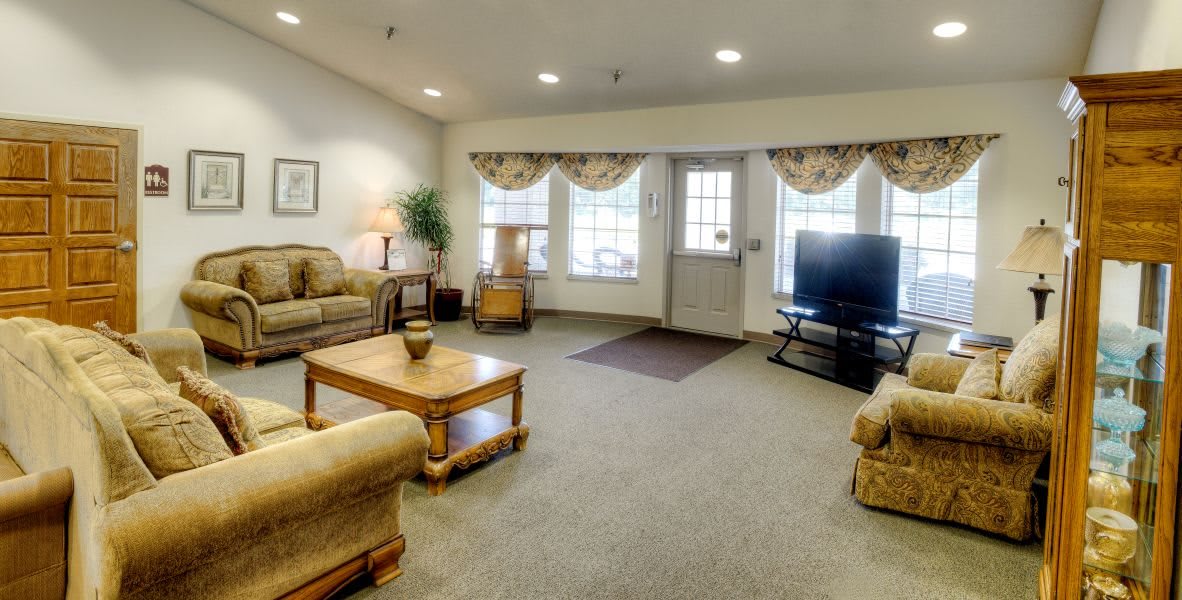 A cozy living room with comfortable seating and a large television.