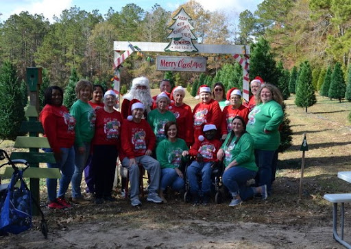 A joyful family gathering to celebrate the Christmas season with Santa Claus at a festive outdoor event.