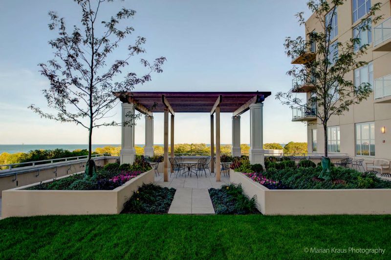 A well-maintained garden area with a pergola and outdoor seating.