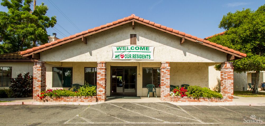 A small building with a welcome sign above the entrance.