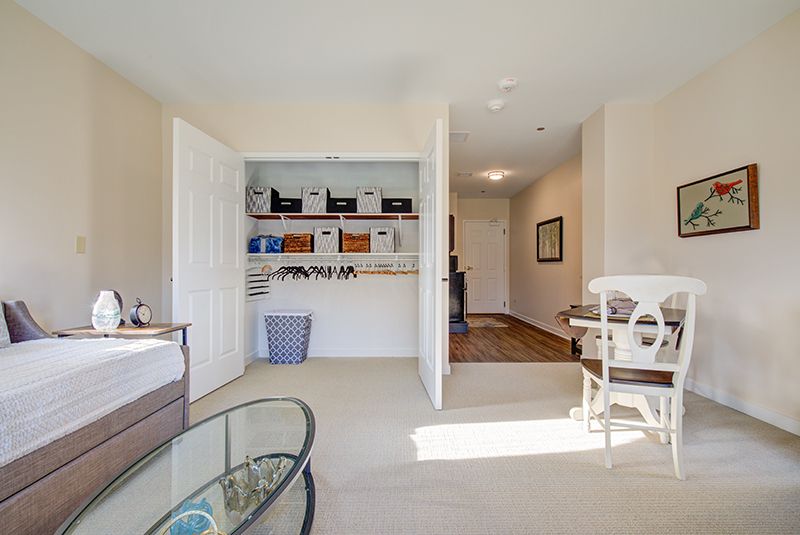 A well-organized home office with a closet and natural lighting.